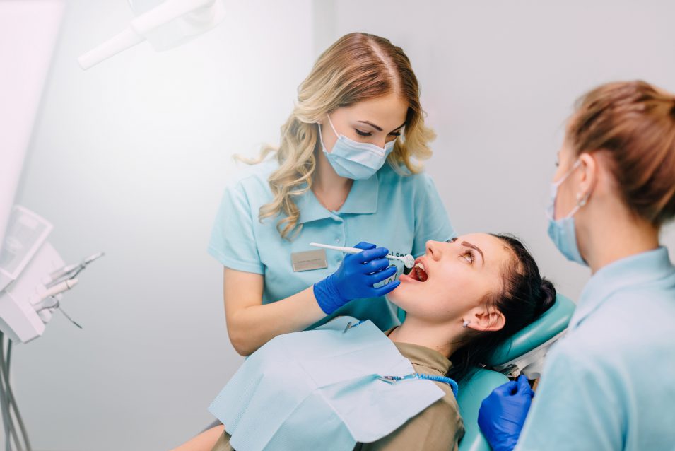 young woman is examined by dentist