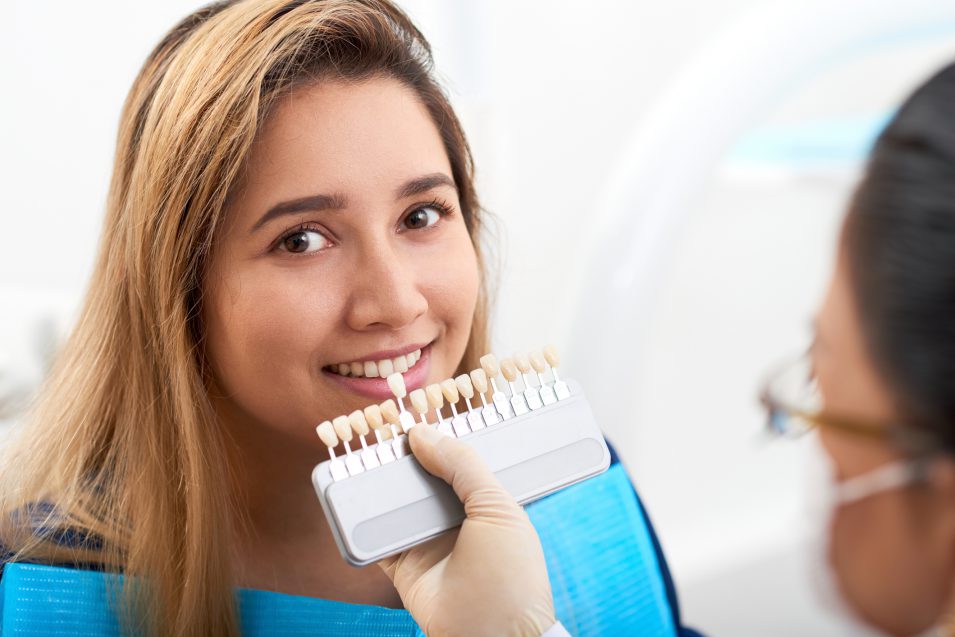 Young woman visiting doctor for teeth whitening